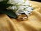 a gold ring on a yellow cloth with white flowers