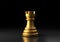 Gold rook chess, standing against black background