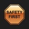 Gold Safety First octagonal shape icon isolated on black background. Long shadow style. Vector