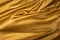 Gold Satin background textured. Soft folded cloth as background texture.