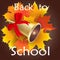 Gold school bell with a red ribbon and maple leaves