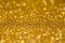 Gold sequins shine bright. Yellow powder. Glitter and bokeh lights