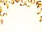 Gold shining confetti flying on white holiday background. Falling party confetti.