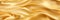 Gold silk satin. Soft folds. Fabric. Gold luxury background. Space for design.Wavy lines.Banner. Wide.Long. Flat lay, top view