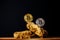 Gold and silver Bitcoin Coins balances on natural stones on dark background. Blockchain cryptocurrency, store of value