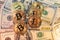 Gold and silver Bitcoin coins on top of dollar bills. Hundred and fifty dollar banknotes. Digital money working with Block chain