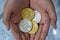 Gold and silver Bitcoins holding in hand, virtual manry and cryptocurrency concept