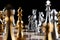 Gold and silver chess figures placed on chessboard