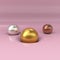 Gold, silver and copper balls dented pink surface