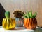 Gold, silver and copper painted geometric concrete planters with cactus and succulent plant. Painted concrete pots for home