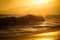 Gold sky and sea water. Sunrise in the sea with soft wave and cloudy. Golden sunrise sunset over the sea waves. Sunrise