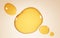 Gold stains of oil, serum droplets or honey on beige background. Bubbles collagen essence, mockup liquid yellow drops of
