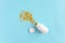 Gold stars confetti fly out white medical bottle on pink background. Concept sleeping pills, melatonin for insomnia, therapy with