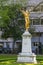 A gold statue of an angel, Memorial to Belgian Sculptor Julien Dillens 1849-1904, Square De Meeus. Brussels,