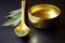 gold tea scoop and loose leaf green tea