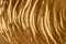 Gold texture. Wavy surface. Gold.