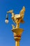Gold thai swan molded figure with lamp in blue sky