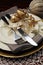 Gold theme Christmas dinner table setting. Close up on cutlery and plates