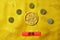 Gold tiger symbol, five lucky coins with chinese zodiac on yellow fabric with traditional chinese ornament with clouds. Chinese