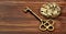 Gold vintage key with clock mechanism, escape room game banner