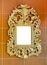 Gold vintage mirror isolated on brown tiles background