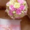 Gold wedding rings and a bouquet of the bride. Pink and white roses