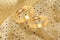 Gold wedding rings on golden festive background
