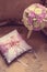 Gold wedding rings lie on a decorative silk pillow with pink satin ribbons next to the bride`s bouquet. Toning with the style of