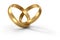 Gold wedding rings linked in shape of heart