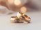 Gold wedding rings rest on a silk-covered table