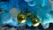 Gold, white and silver shiny Christmas balls. Blue and white ink in the water.