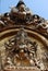 Gold-winged bird and big black sky statue along Nepal temple door