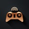 Gold Wireless gamepad icon isolated on black background. Game controller. Long shadow style. Vector