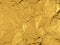 Gold wrinkled foil texture or background