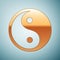 Gold Yin Yang symbol icon on blue background