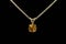 Gold Zircon pendant, silver chain. Black background.