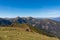 Goldeck - Herd of wild horses grazing on alpine meadow with scenic view of magical mountain of Karawanks and Julian Alps