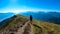 Goldeck - Man with baby carrier on hiking trail with scenic view of magical mountain peaks Karawanks and Julian Alps