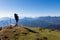 Goldeck - Man with baby carrier looking at magical mountain peaks of Karawanks and Julian Alps seen from Goldeck