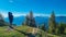 Goldeck - Man with baby carrier looking at magical mountain peaks of Karawanks and Julian Alps seen from Goldeck