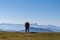 Goldeck - Single wild horse grazing on alpine meadow with scenic view of magical mountain of Karawanks and Julian Alps