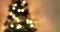 Golden abstract blinking blurred Christmas tree lights bokeh on gold warm background, festive holiday