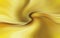 A golden abstraction with a vortex in the center. Swirled lines on a yellow background