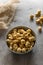 Golden airy popcorn in a gray plate on a concrete table on a piece of light burlap, fried crispy corn for watching a movie or