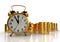 Golden alarm clock standing on a stack of golden coins. White background. Time is money concept.