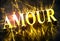 Golden `AMOUR` word in french with caustic - translation for `LOVE`