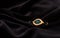 Golden amulet eye pendant bracelet on velvet dark fabric