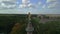 Golden angel rises into blue sky with fleecy clouds. Gorgeous aerial view flight