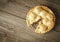 Golden Apple Pie on Rustic Barnwood With One Slice Gone