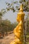 Golden asian angel statue beside the walkway